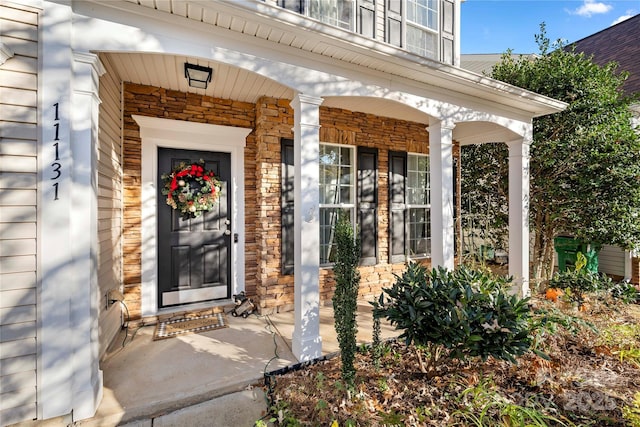 view of exterior entry with a porch