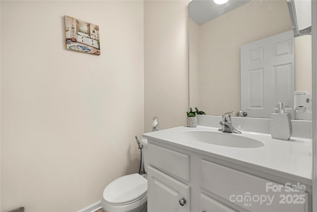 bathroom with toilet and vanity