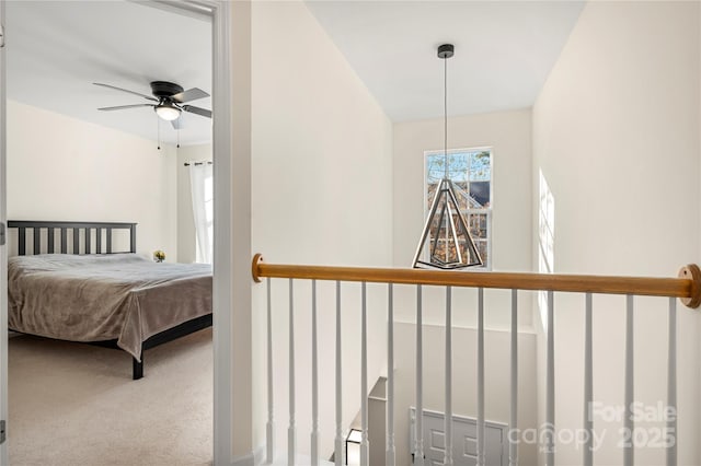 bedroom featuring ceiling fan and carpet