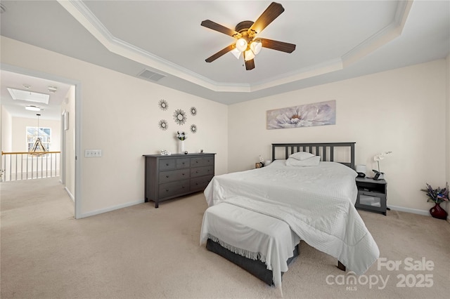 carpeted bedroom featuring ceiling fan, crown molding, and a tray ceiling