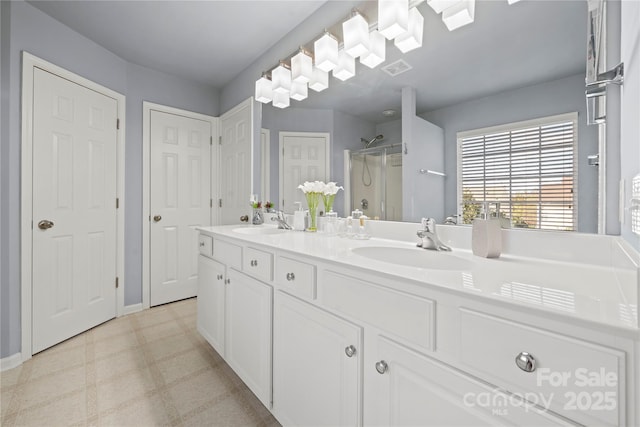 bathroom with an enclosed shower and vanity