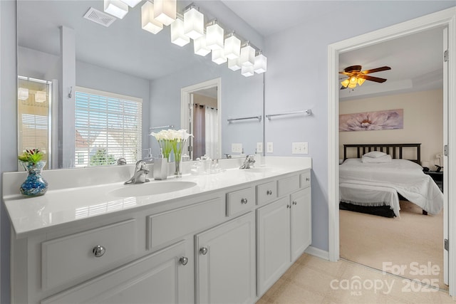 bathroom with ceiling fan and vanity