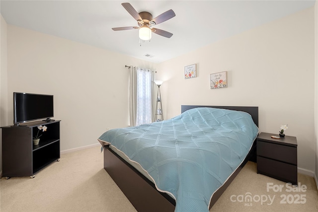 bedroom featuring light carpet and ceiling fan