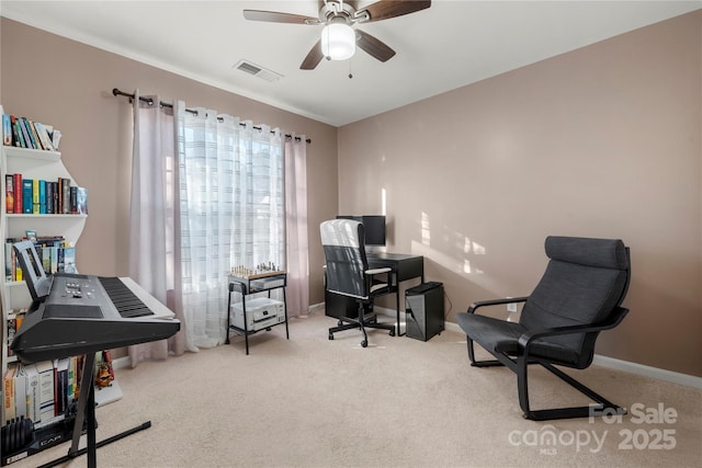 office space featuring ceiling fan and light carpet