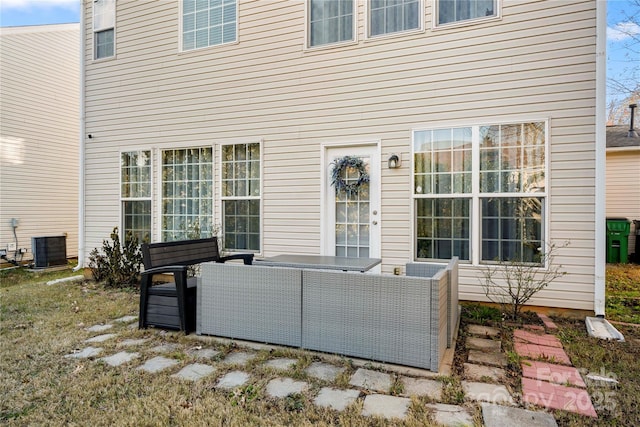 back of house featuring cooling unit and an outdoor living space