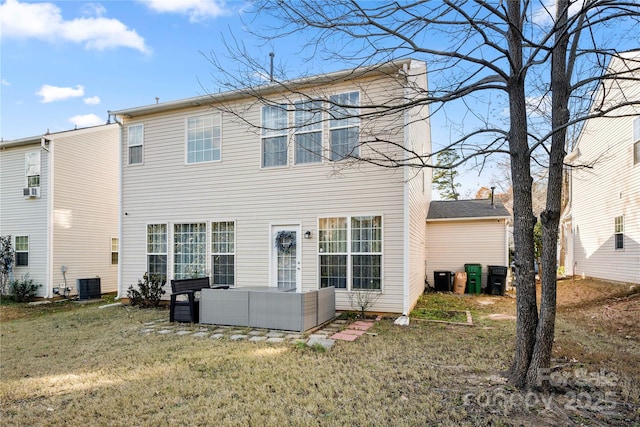 rear view of property featuring a lawn, central AC unit, and an outdoor living space