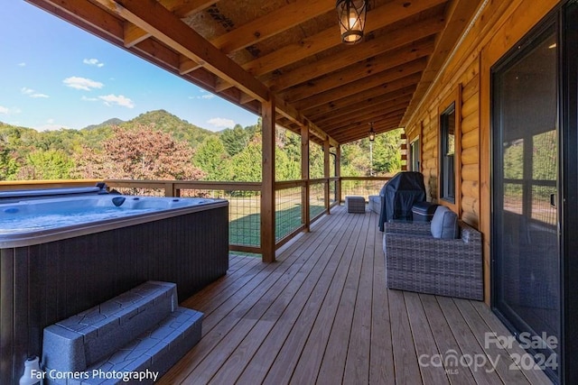 wooden terrace featuring a grill and a hot tub