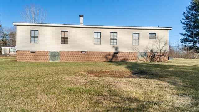 view of side of home with a lawn