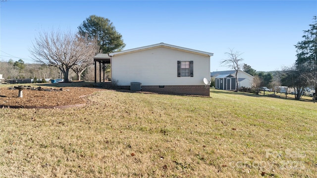 view of property exterior featuring a yard and central air condition unit