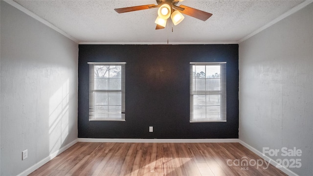 empty room with ceiling fan, hardwood / wood-style floors, and a textured ceiling