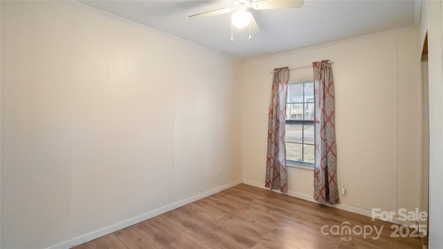 empty room with ceiling fan, wood-type flooring, and ornamental molding