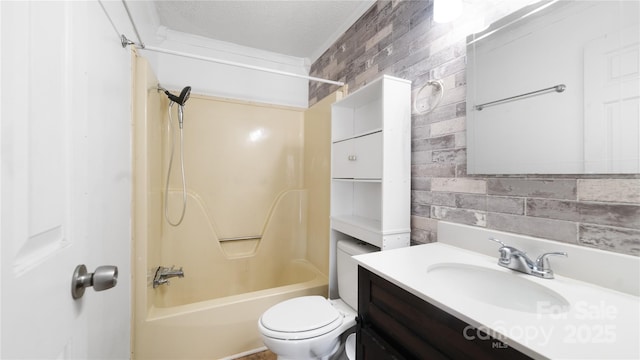 full bathroom featuring vanity, toilet, shower / washtub combination, and brick wall