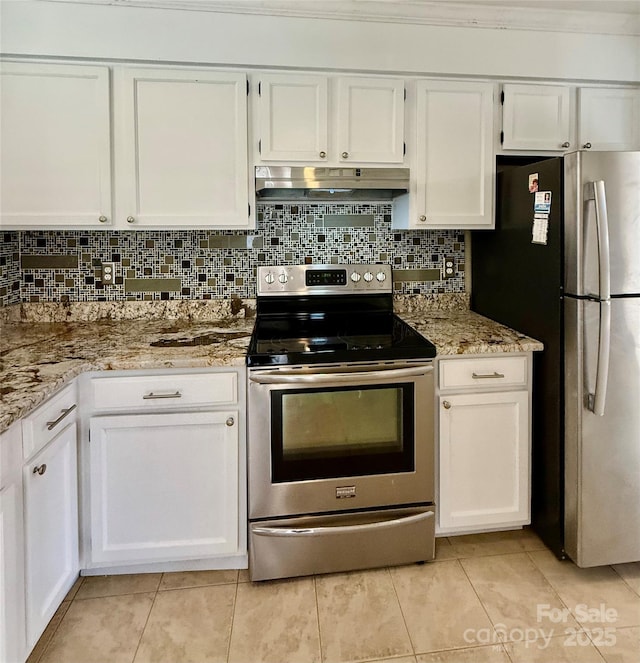 kitchen featuring light tile patterned floors, appliances with stainless steel finishes, white cabinetry, and light stone countertops