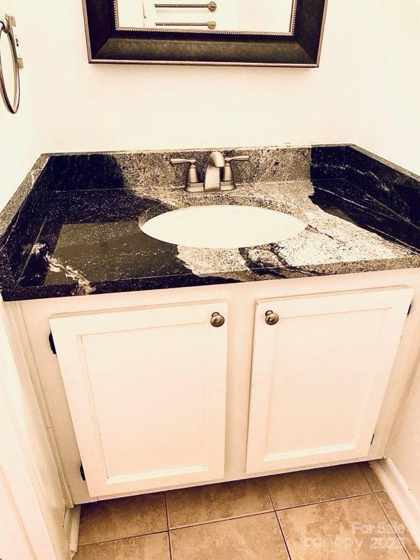 bathroom featuring tile patterned flooring and vanity