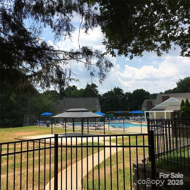 view of pool with a gazebo and a lawn