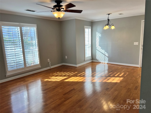 unfurnished room featuring crown molding, hardwood / wood-style floors, and ceiling fan with notable chandelier