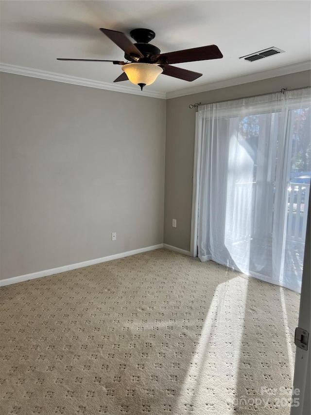 unfurnished room with baseboards, visible vents, light colored carpet, ceiling fan, and crown molding