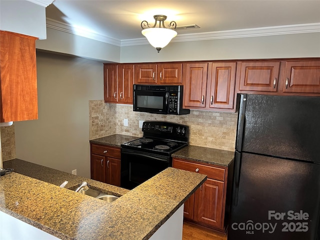 kitchen featuring tasteful backsplash, ornamental molding, a sink, a peninsula, and black appliances