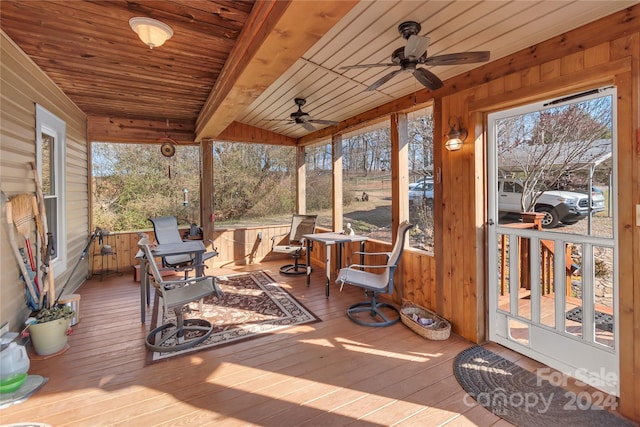 sunroom featuring ceiling fan, beam ceiling, and wood ceiling