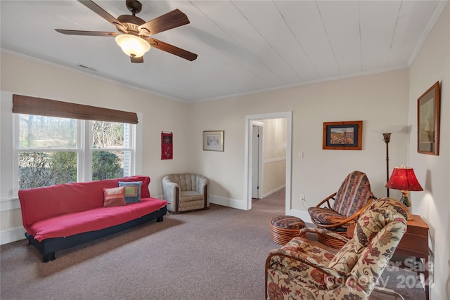 carpeted living room with ceiling fan and crown molding