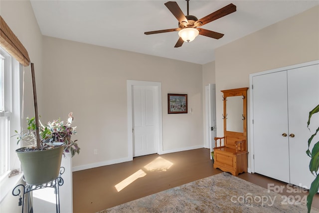 bedroom featuring ceiling fan, dark wood-type flooring, and a closet