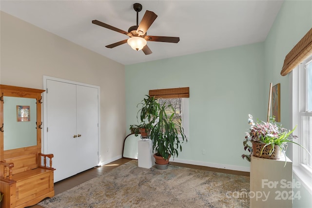 interior space with ceiling fan