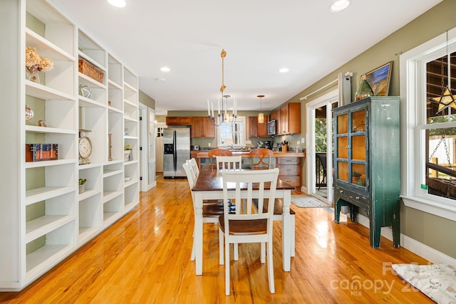 dining area featuring a chandelier and light hardwood / wood-style floors