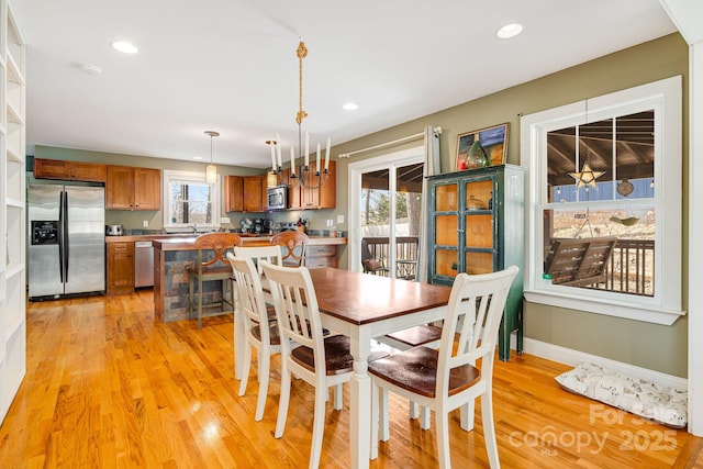 dining area featuring sink and light hardwood / wood-style flooring