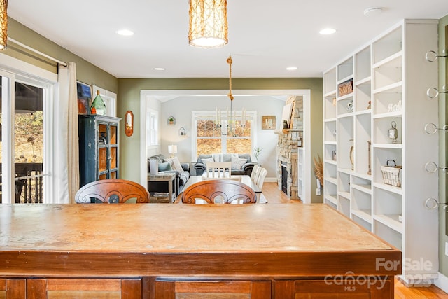 interior space with plenty of natural light and a stone fireplace