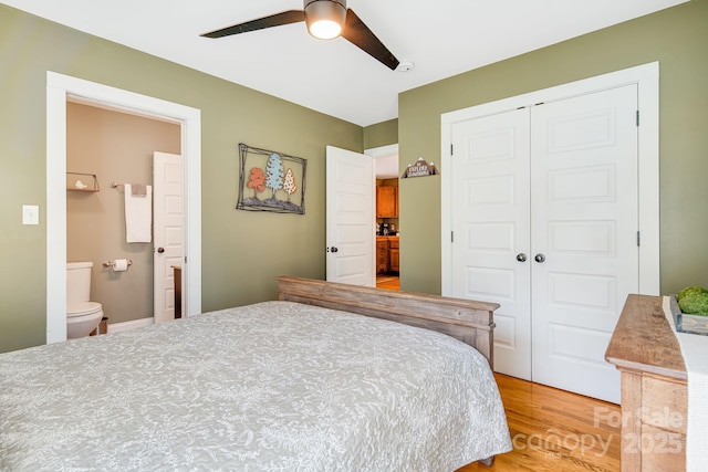 bedroom with connected bathroom, wood-type flooring, a closet, and ceiling fan