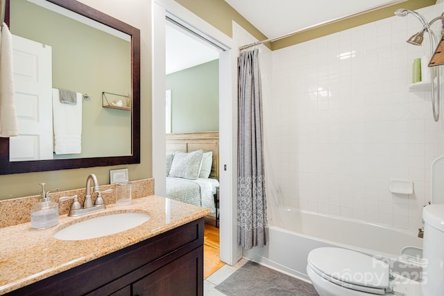 full bathroom with tile patterned flooring, toilet, vanity, and shower / bath combo with shower curtain