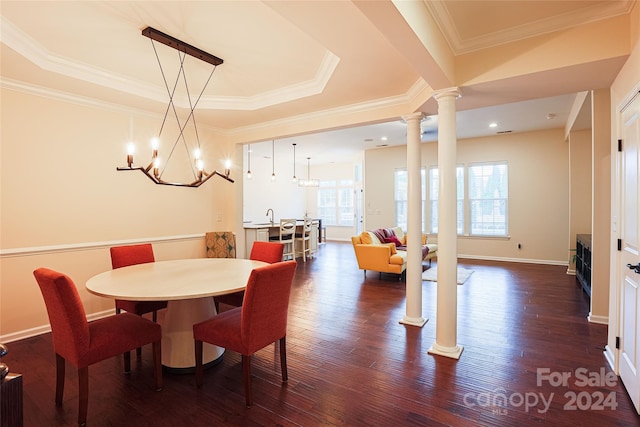 dining space with dark hardwood / wood-style flooring, a wealth of natural light, and a chandelier