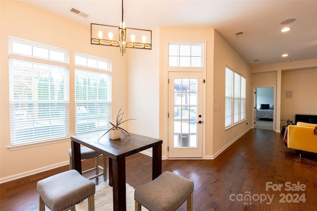 dining room with a chandelier, dark hardwood / wood-style flooring, and a wealth of natural light