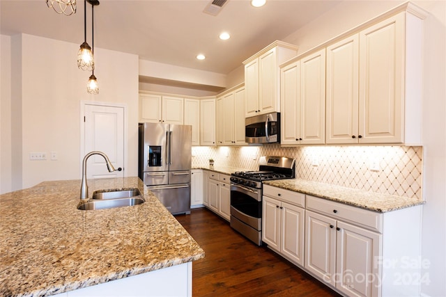 kitchen with white cabinetry, sink, hanging light fixtures, dark hardwood / wood-style flooring, and appliances with stainless steel finishes