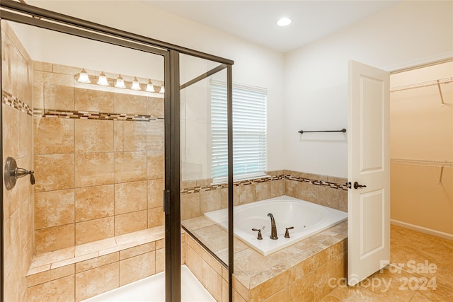 bathroom featuring shower with separate bathtub and tile patterned floors