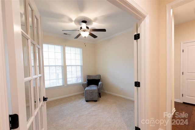 sitting room with french doors, light colored carpet, ceiling fan, and crown molding