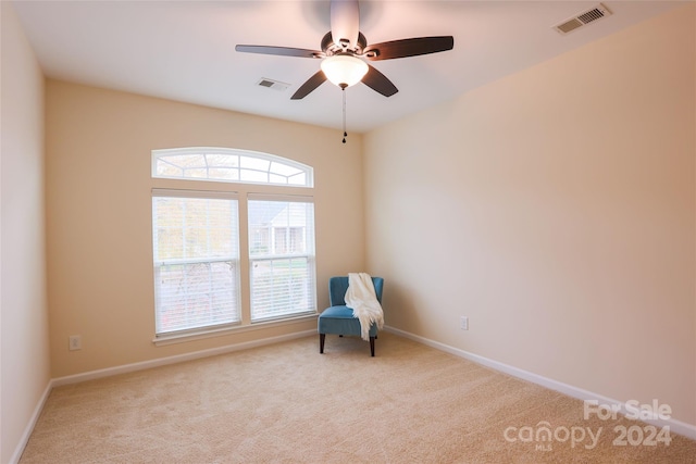 unfurnished room with ceiling fan and light colored carpet