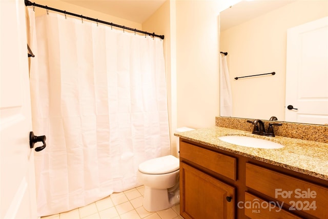 bathroom with tile patterned floors, vanity, and toilet