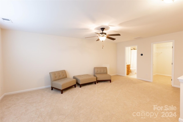 unfurnished room featuring ceiling fan and light carpet