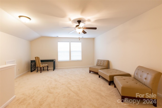 living area with ceiling fan, light colored carpet, and lofted ceiling