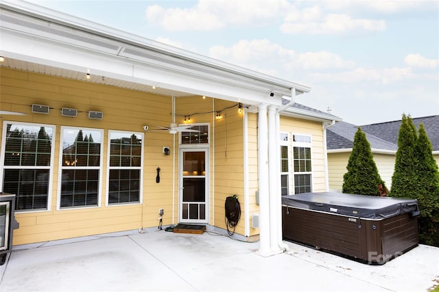 view of patio featuring ceiling fan and a hot tub