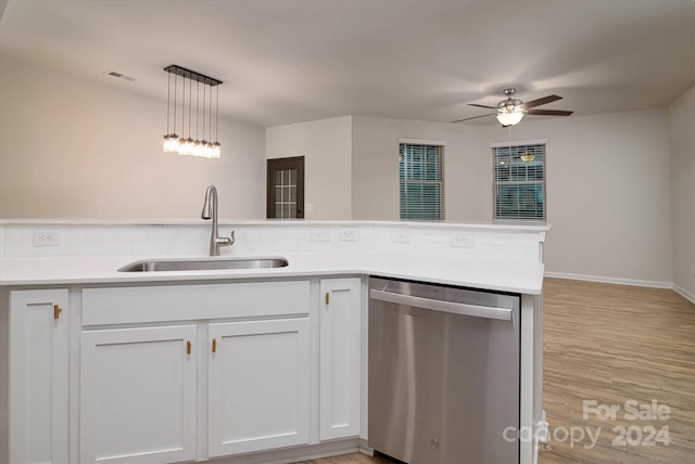 kitchen with white cabinetry, sink, stainless steel dishwasher, and light hardwood / wood-style floors