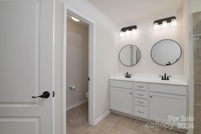 bathroom featuring tile patterned floors, vanity, and toilet