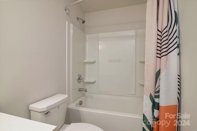 bathroom with shower / bath combo with shower curtain and toilet