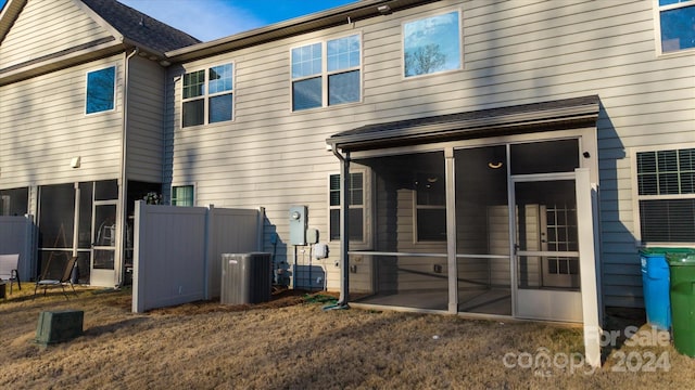 back of property with a sunroom and cooling unit