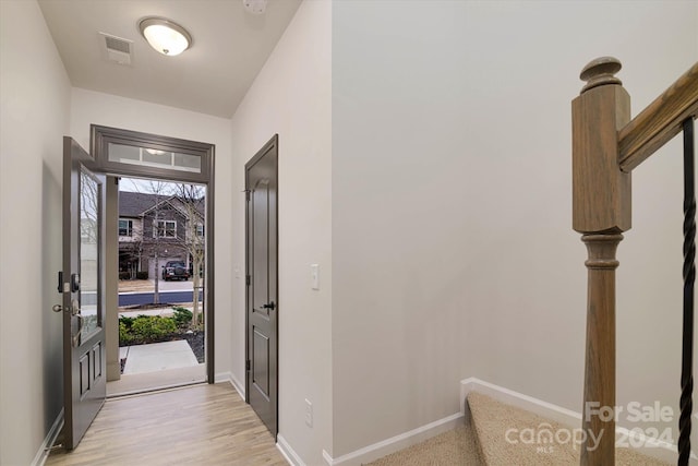 foyer entrance with light hardwood / wood-style floors