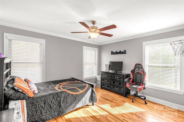 bedroom featuring ceiling fan, crown molding, and hardwood / wood-style flooring