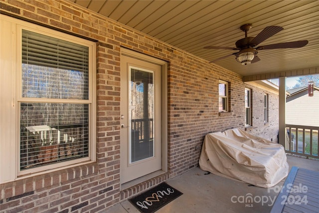 entrance to property with covered porch and ceiling fan