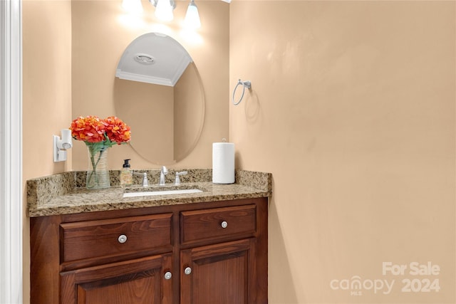 bathroom featuring vanity and ornamental molding