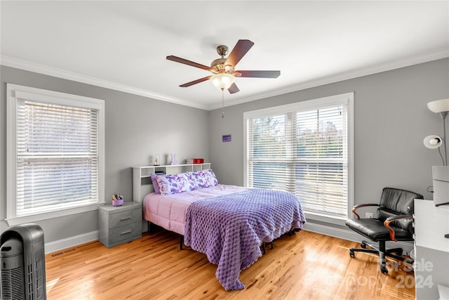 bedroom featuring ceiling fan, light hardwood / wood-style floors, and ornamental molding